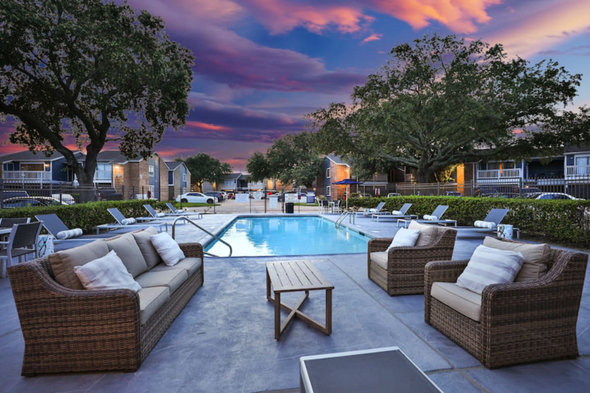 Swimming pool with lounge chairs at Barringer Square in Webster, Texas