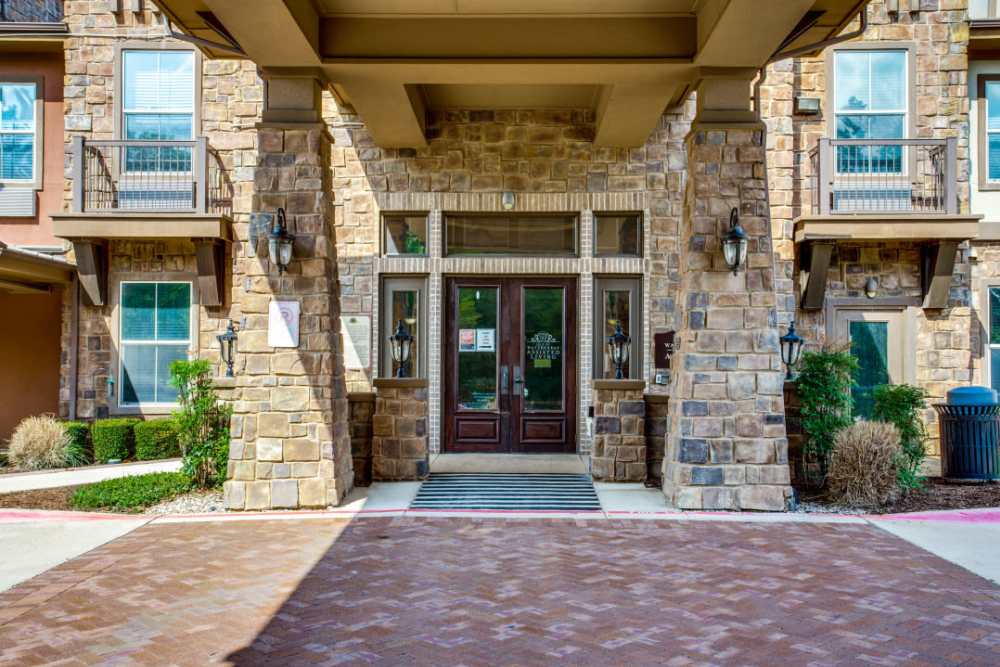 Front facing entrance of community with nice wooden doors