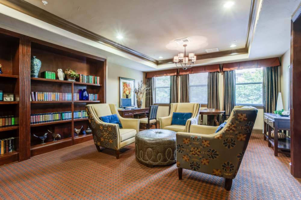 Library at Isle at Cedar Ridge in Cedar Park, Texas, featuring bookshelves and comfortable seating for reading.