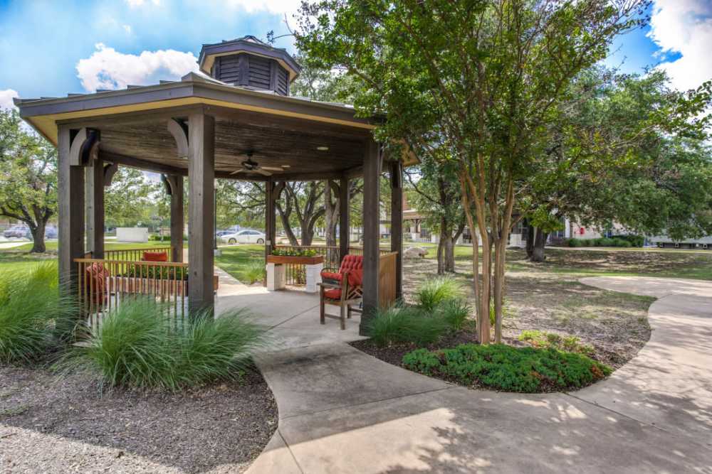 A sitting area with a couch and two chairs at Isle at Cedar Ridge in Cedar Park, Texas
