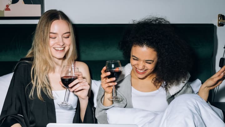 friends laughing with wine | hosting overnight guests 