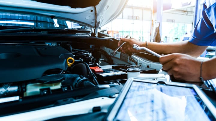 car mechanic checking the condition of a car at an auto center