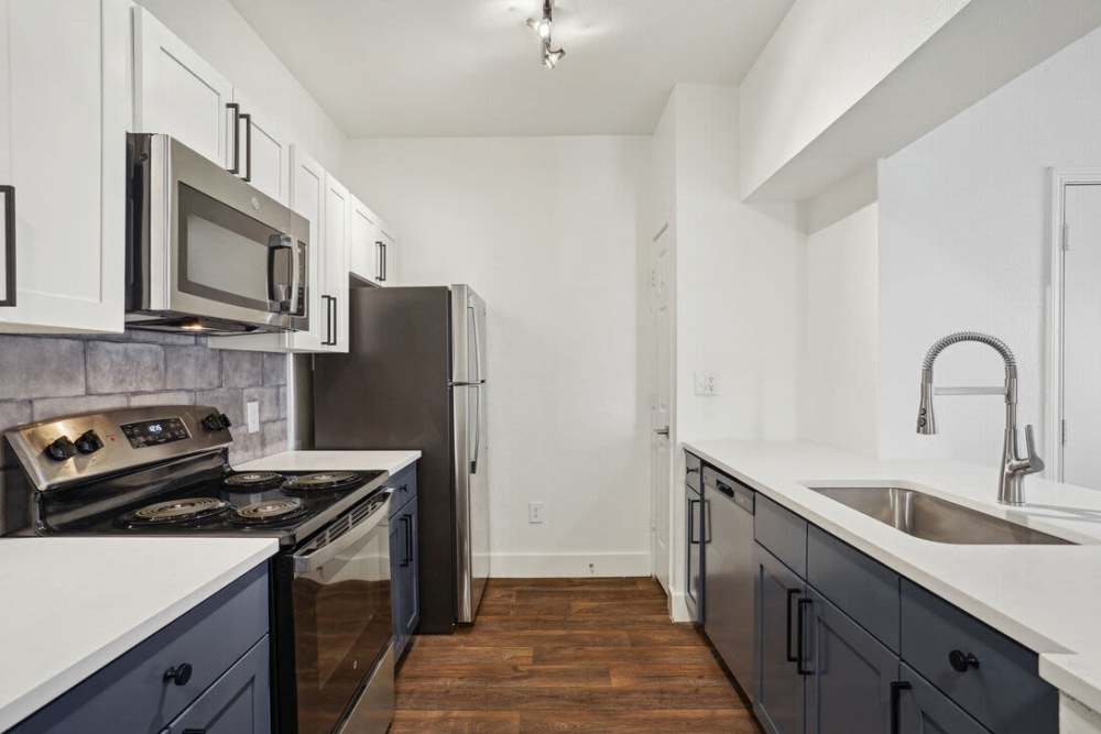 Kitchen with wood-style flooring at Mission Eagle Pointe in Allen,Texas