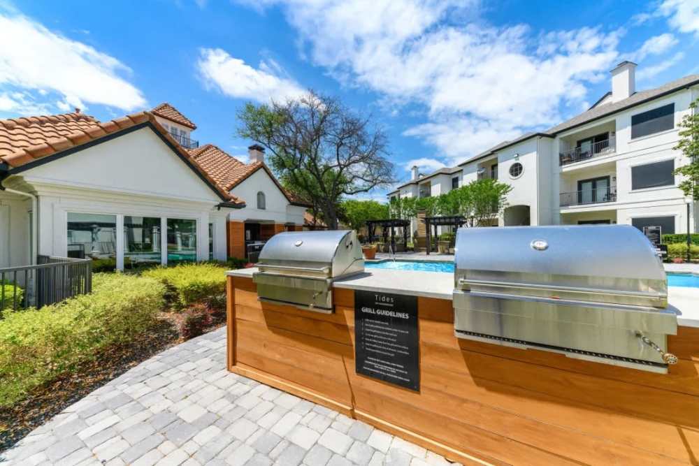 Kitchen island with waterfall faucet and dishwasher at Benton in Dallas, Texas, 