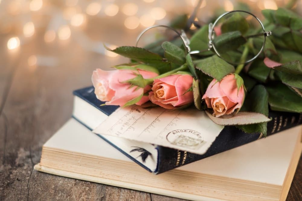 stack of books with flowers and glasses at River Commons Senior Living in Redding, California