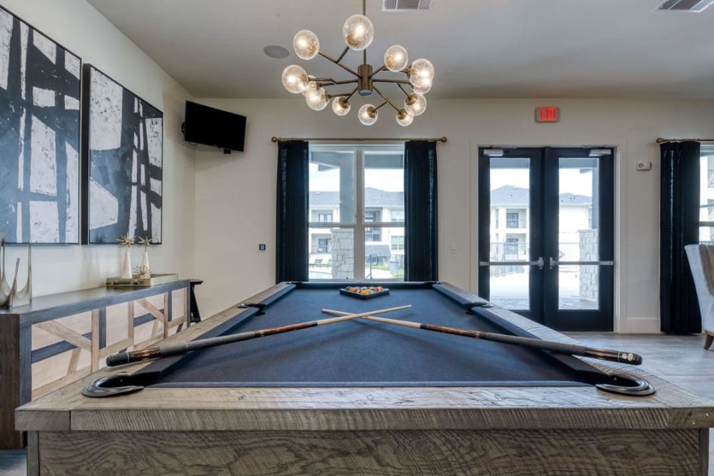 Game room with a billiards table and more in the resident clubhouse at Palmetto Pointe in San Antonio, Texas