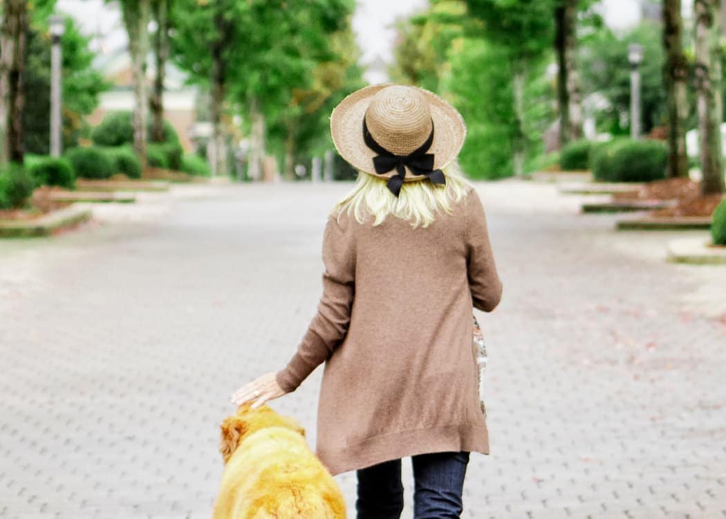 Resident taking her dog for a walk at Widdicombe Place in Etobicoke, Ontario