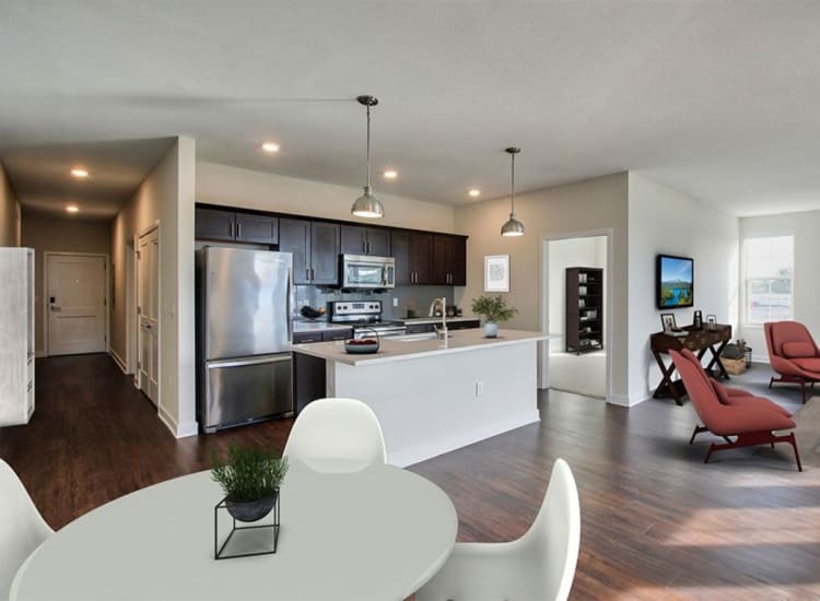 Spacious, open-concept living area in a model home at Pinnacle North Apartments in Canandaigua, New York