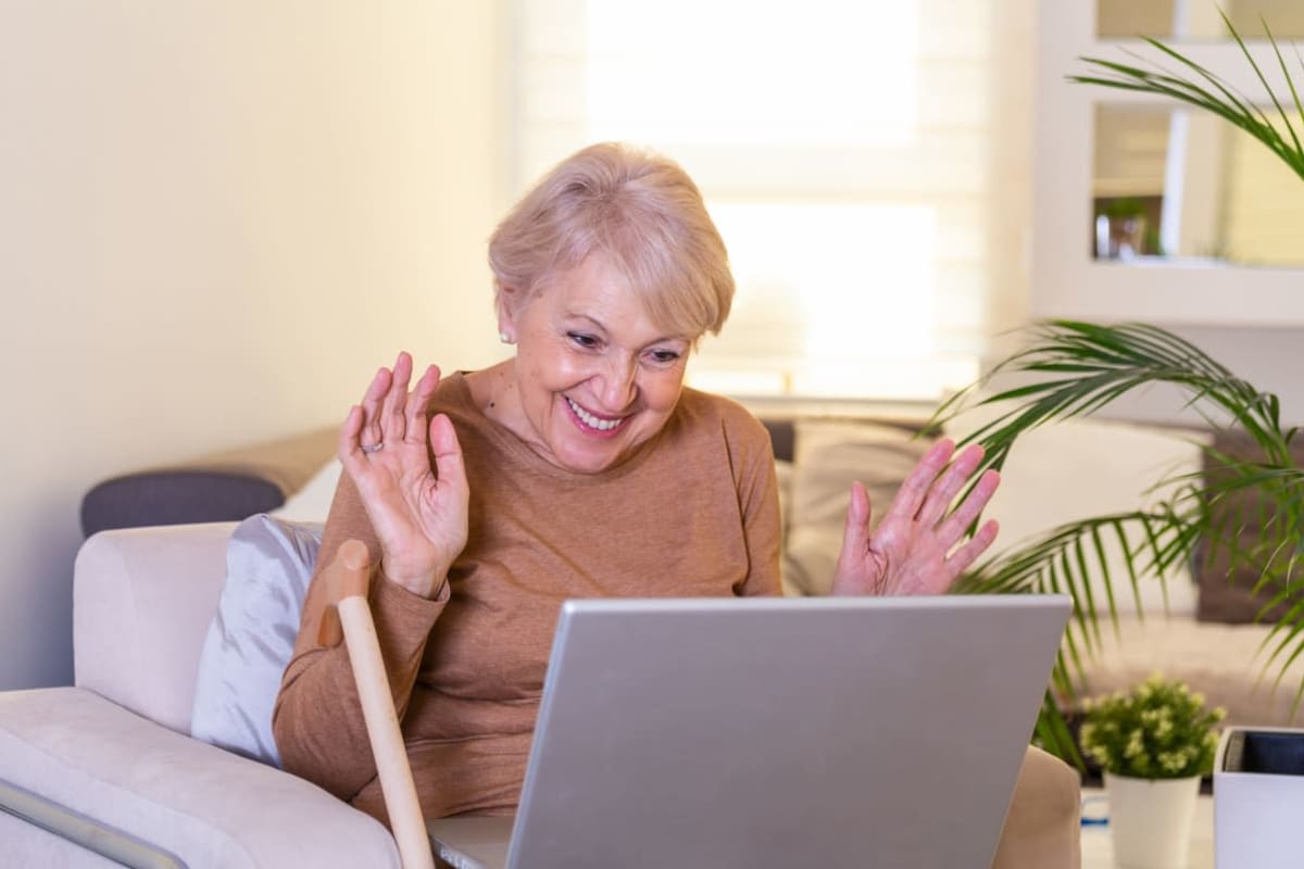 A resident video chatting with her grand children at Canoe Brook Assisted Living & Memory Care in Catoosa, Oklahoma