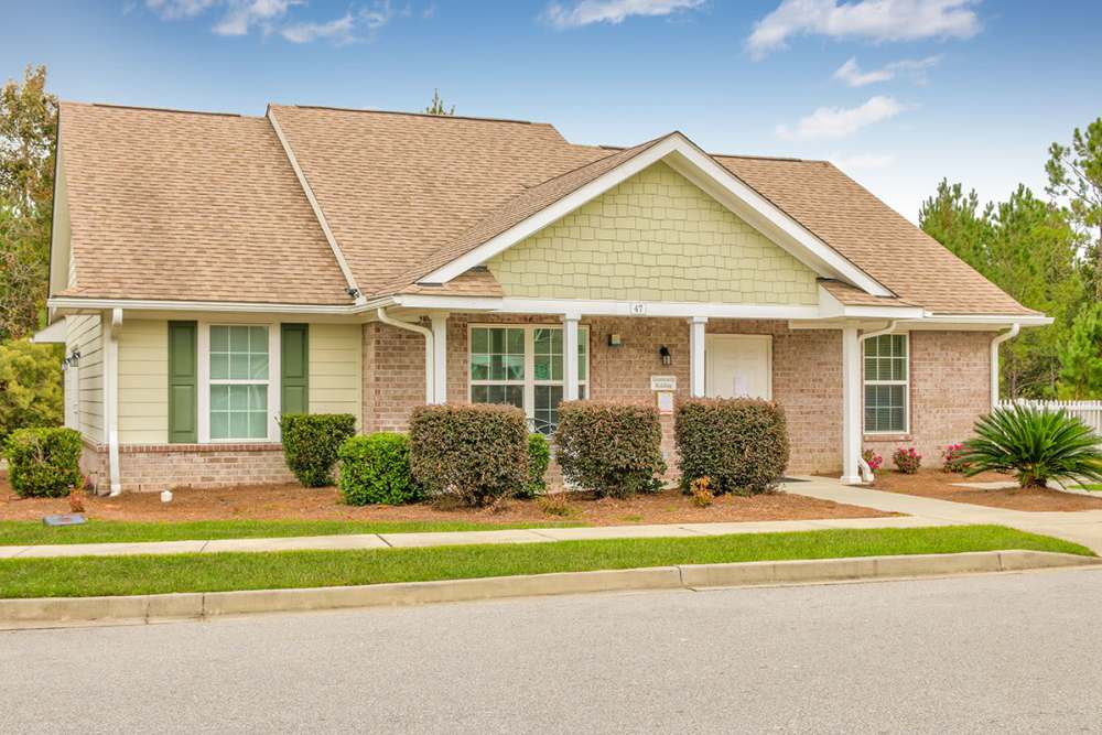 Beautiful exterior view of the apartment with green lawn in the front yard at Jenny Greene in Hardeeville, South Carolina