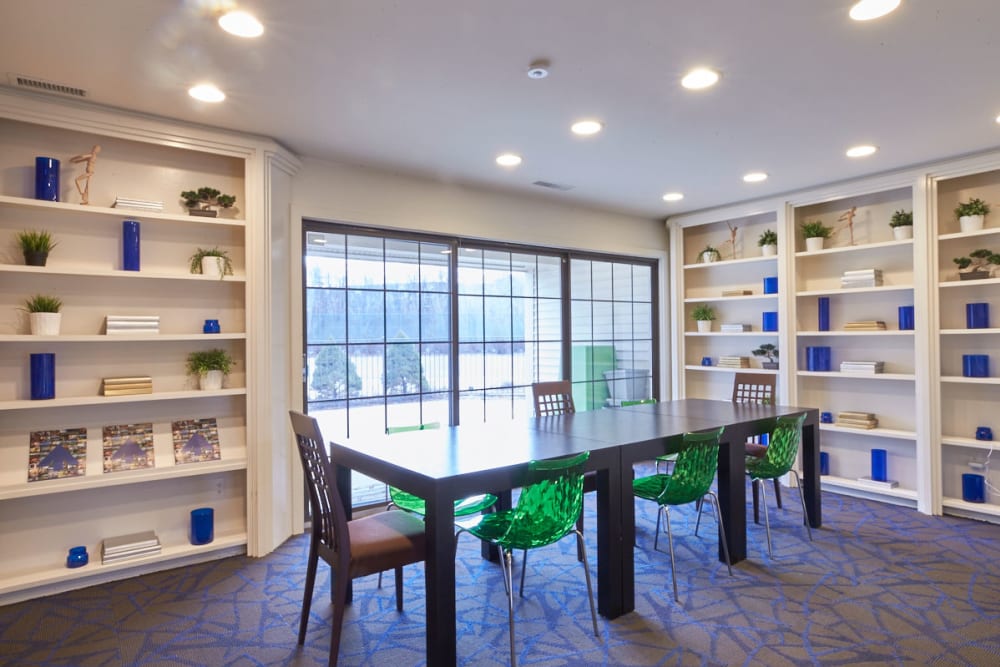 Meeting space with floor-to-ceiling bookshelves and large windows at Muirwood in Farmington Hills, Michigan