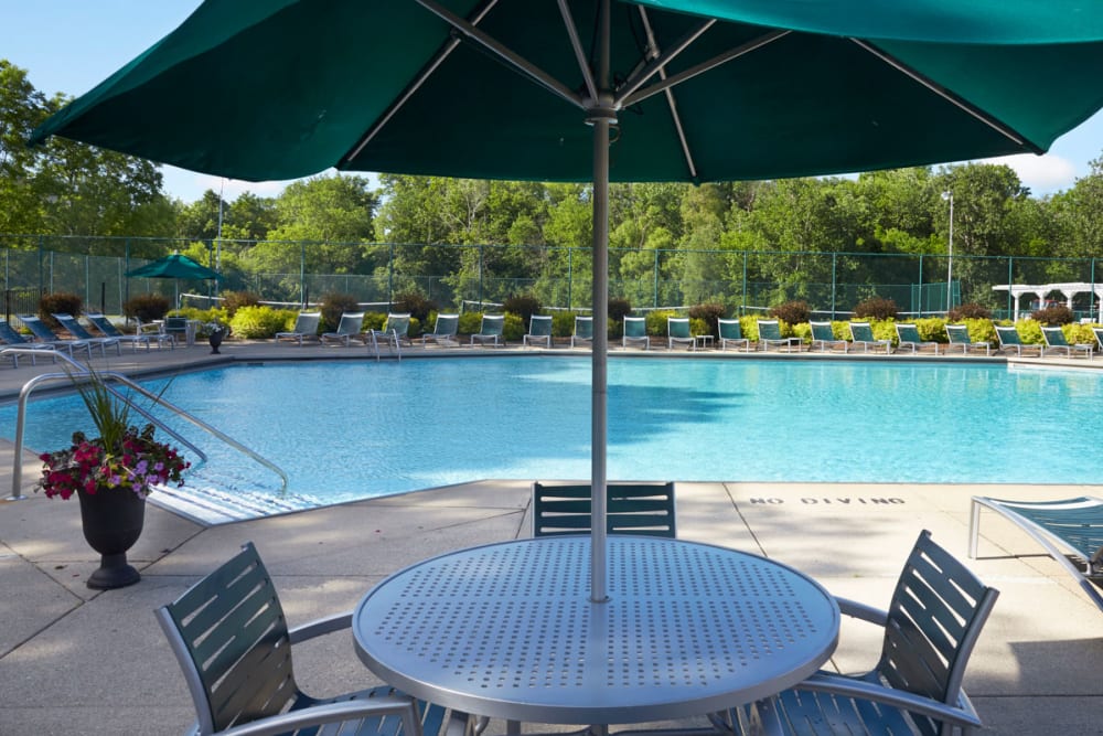 Outdoor swimming table with sundeck patio tables at Muirwood in Farmington Hills, Michigan
