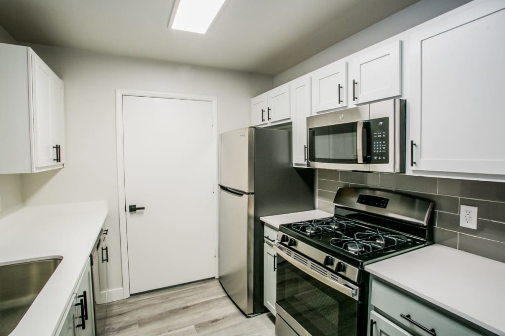 Stainless-steel appliances in an apartment kitchen at Site SUMMIT Apartments in Las Vegas, Nevada