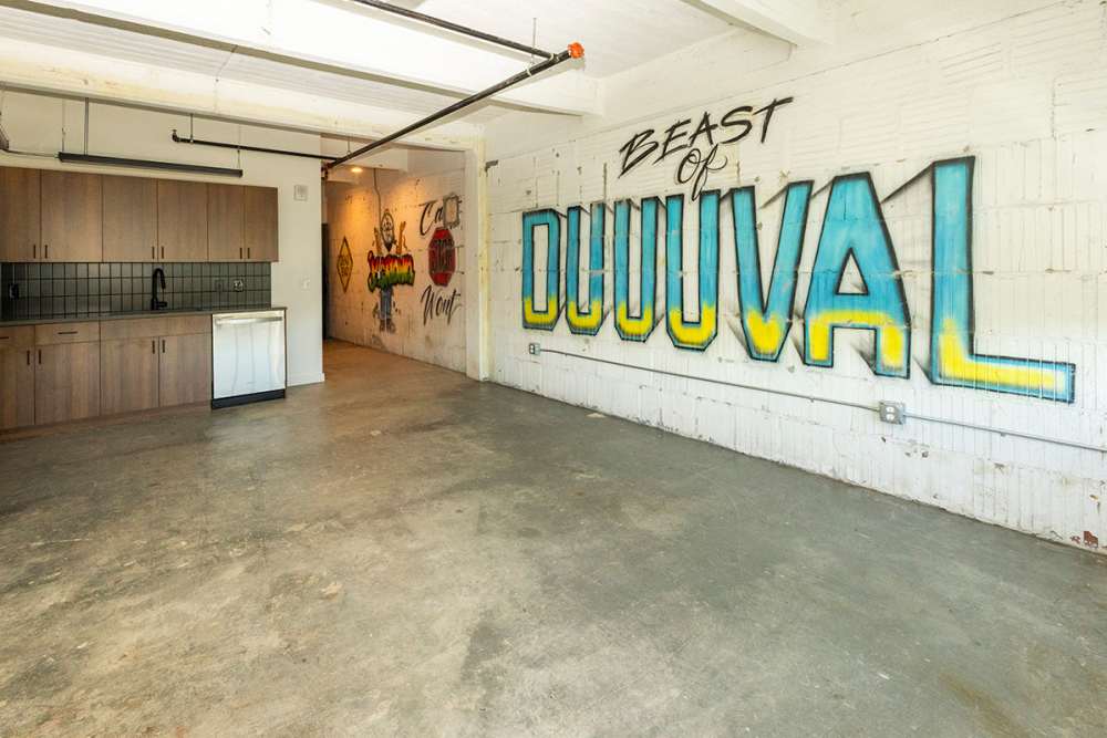 Empty unit at Union Terminal Warehouse in Jacksonville, Florida with graffiti mural on the wall