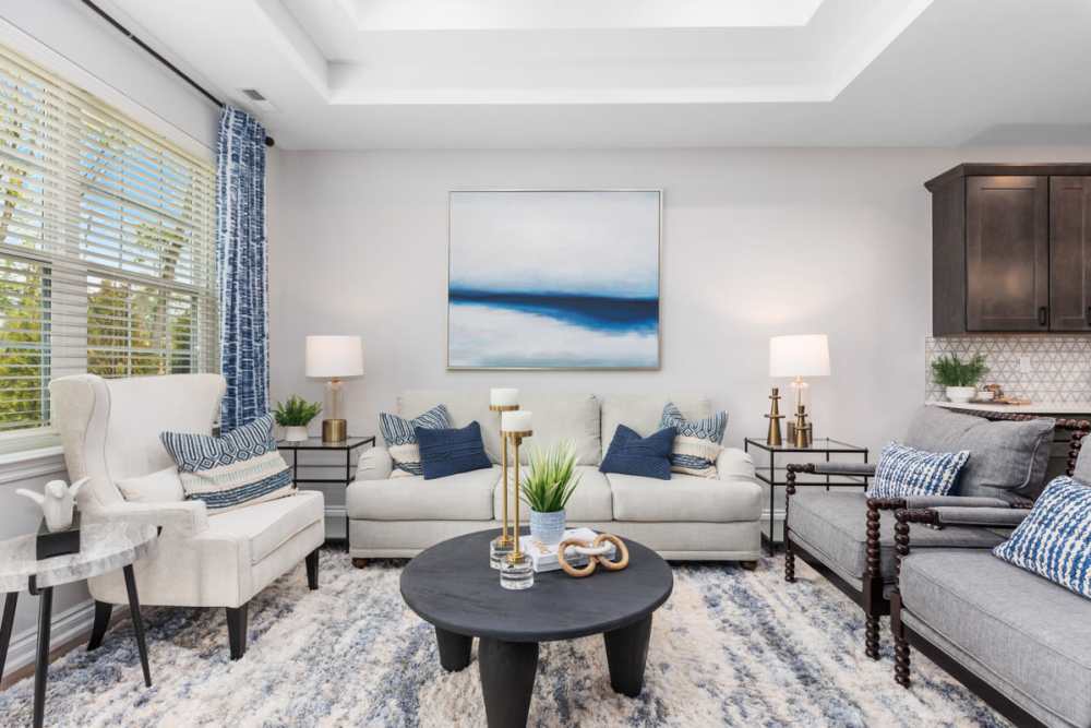 Spacious living room with large couch, chair and center table at Encore at West Valley in White Lake, Michigan