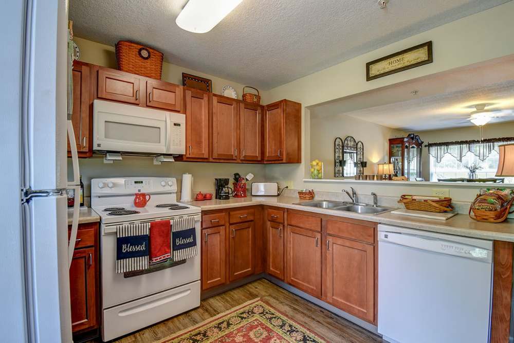 Cozy kitchen with wooden cabinets at Oak Valley Gardens in Glenville,West Virginia