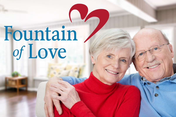 Elderly couple with logo of the Fountain of Love fund