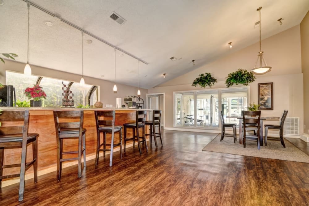 Clubhouse lounge with a bar table at Devonwood Apartment Homes in Charlotte, North Carolina