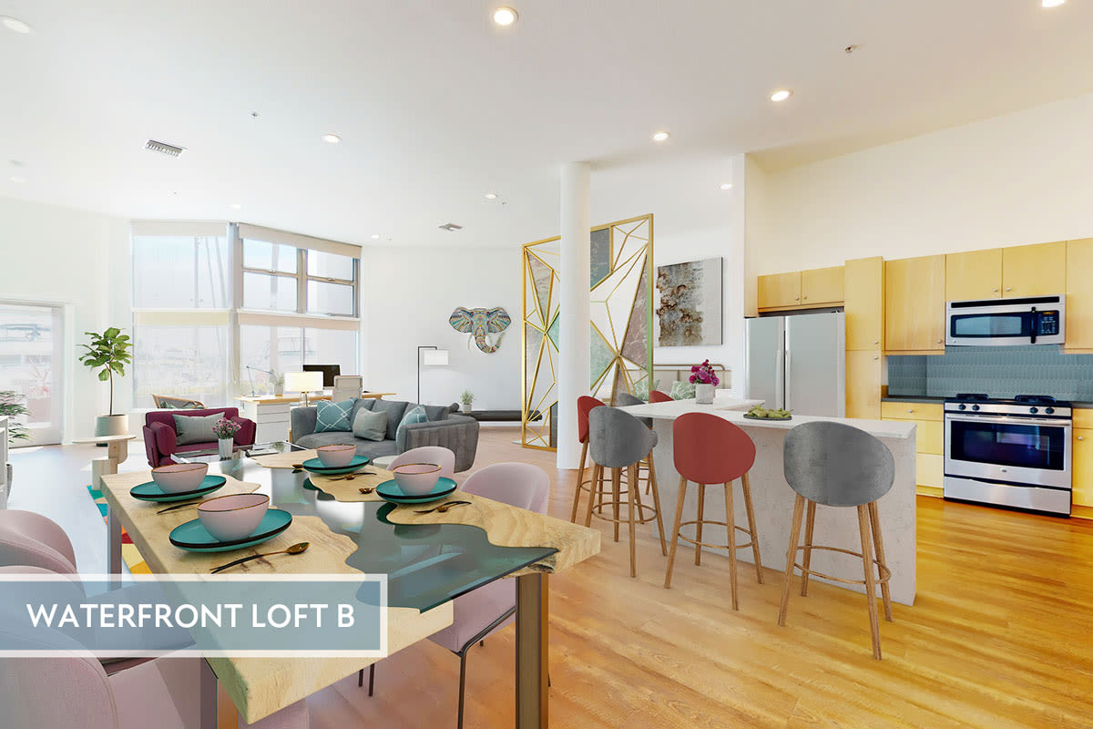 Spacious loft apartment's dining room, modern kitchen with stainless steel appliances, and hardwood floors at Esprit Marina del Rey in Marina del Rey, California