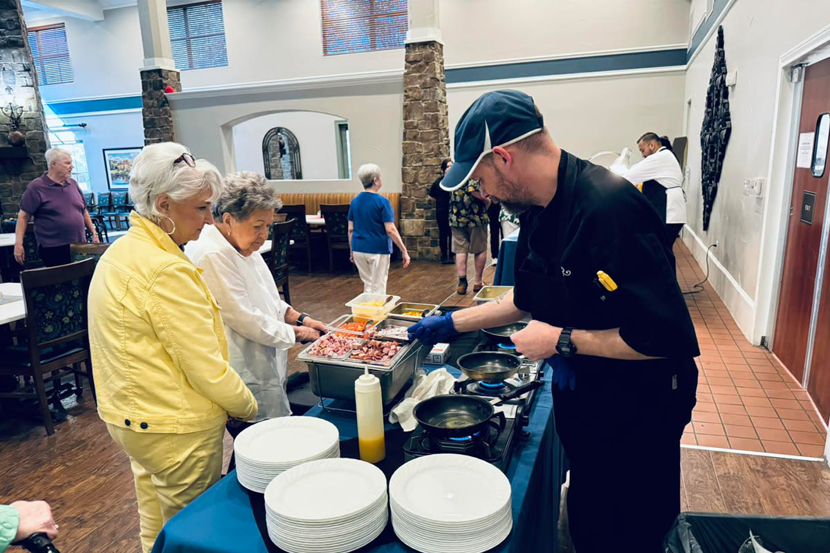 Residents being served food from worker at Watercrest at Mansfield