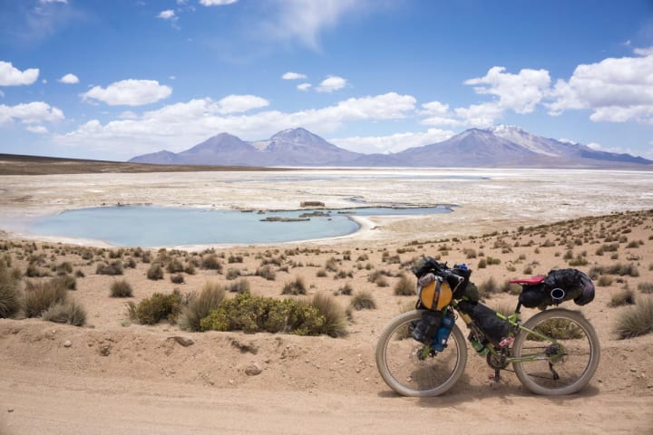 A bike on a dirt trail with a beautiful view