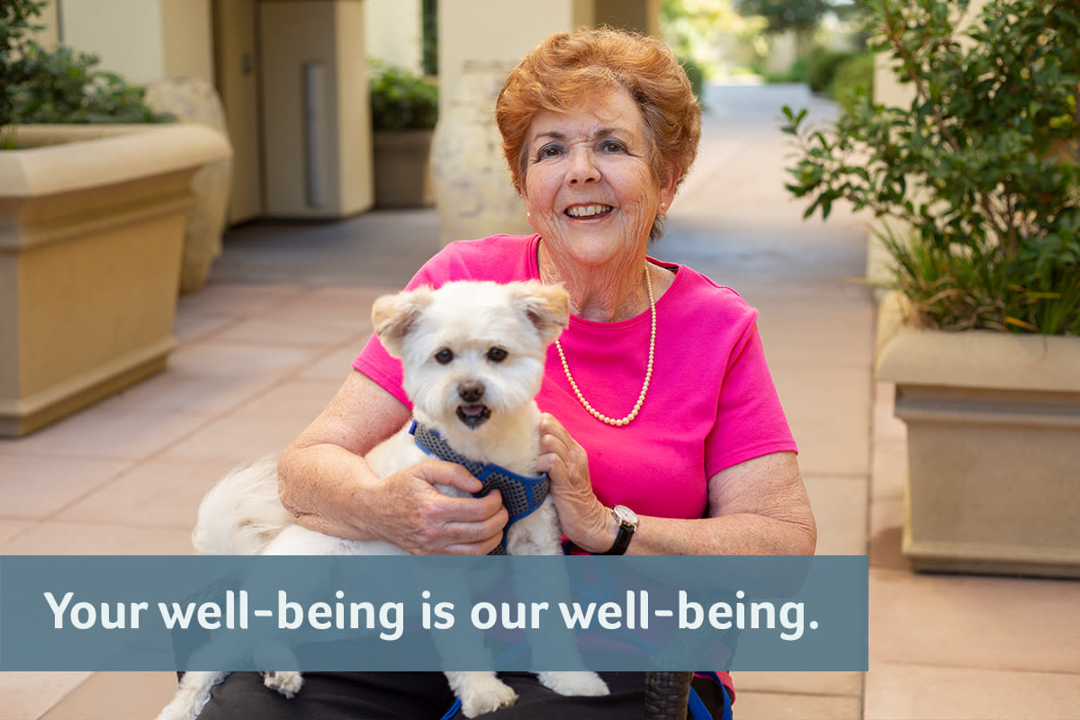 A resident holding her dog at Merrill Gardens at Auburn in Auburn, Washington.