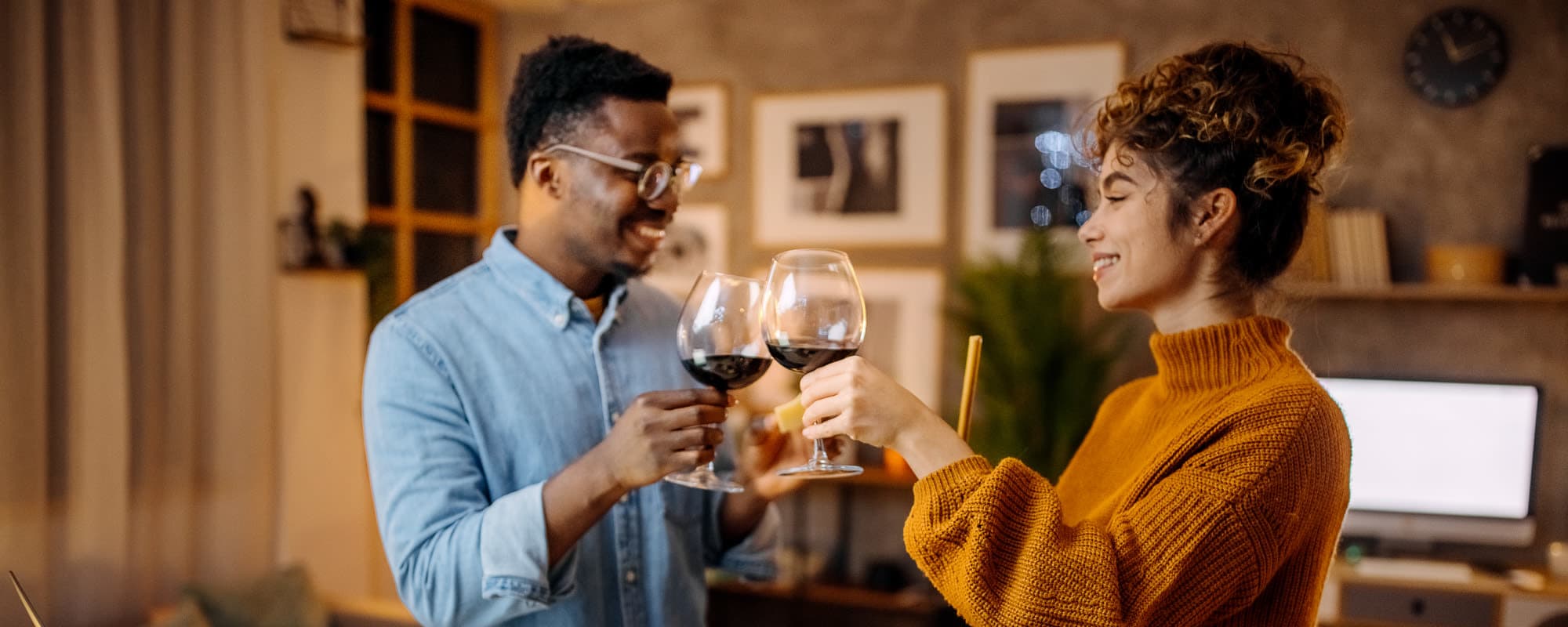 Resident couple have a toast to their new apartment at The Hampton on Jupiter in Dallas, Texas