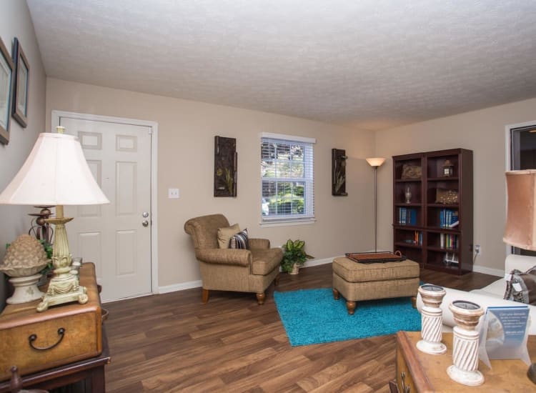 Comfortable living area with hardwood flooring in a model home at The Arbors at Smyrna in Smyrna, Georgia
