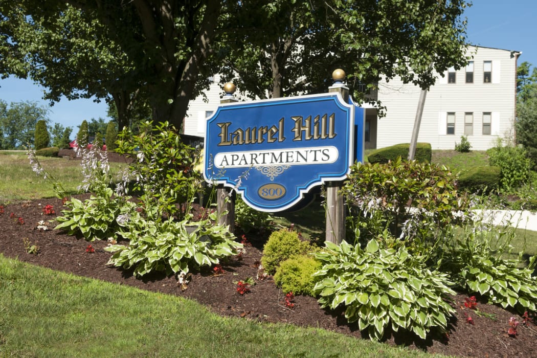 Apartment sign surrounded by beautiful landscaping at Laurel Hill Apartments in Lindenwold, New Jersey