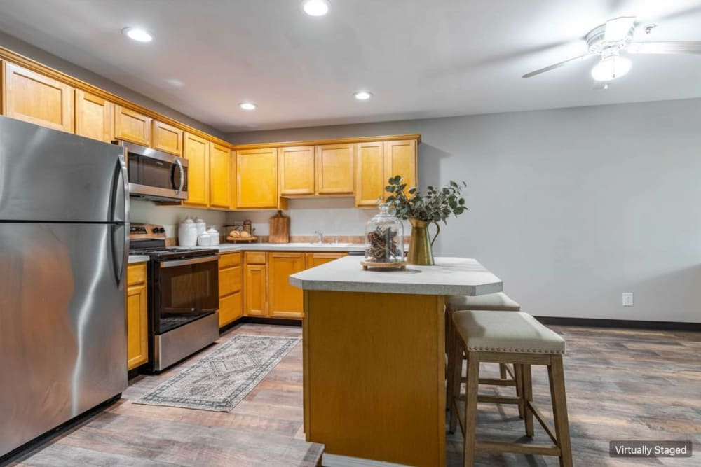 Kitchen with stainless steel appliances at Aravia Apartments in Tacoma, Washington