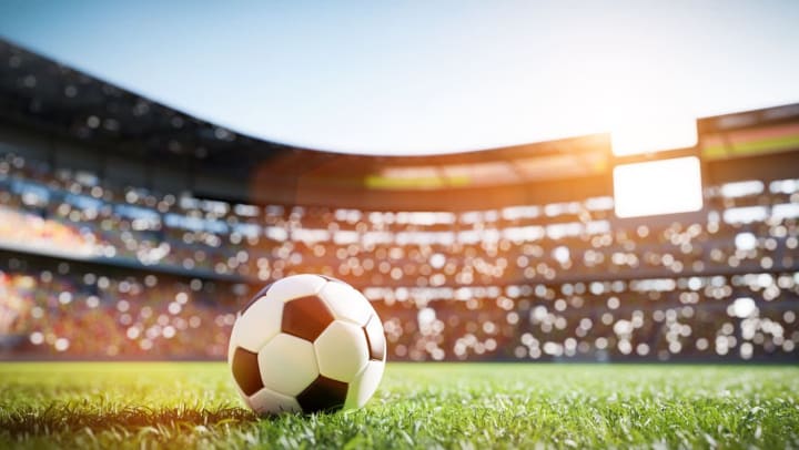 Soccer ball on grass field in a stadium