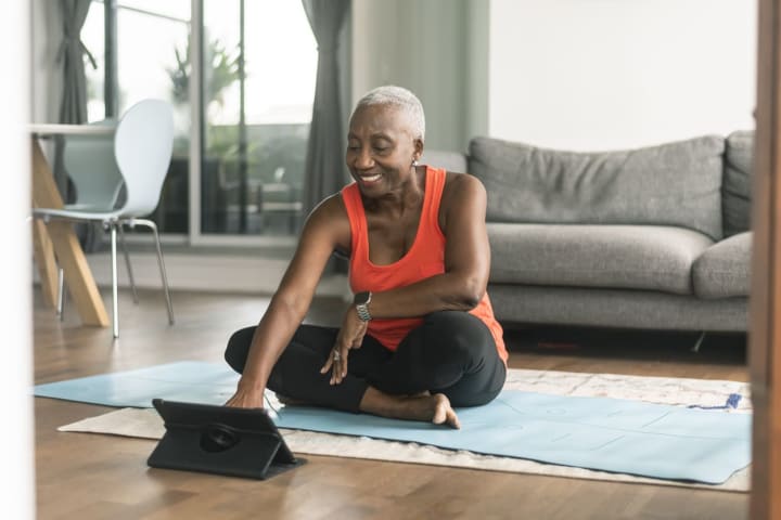 Senior woman taking online yoga class