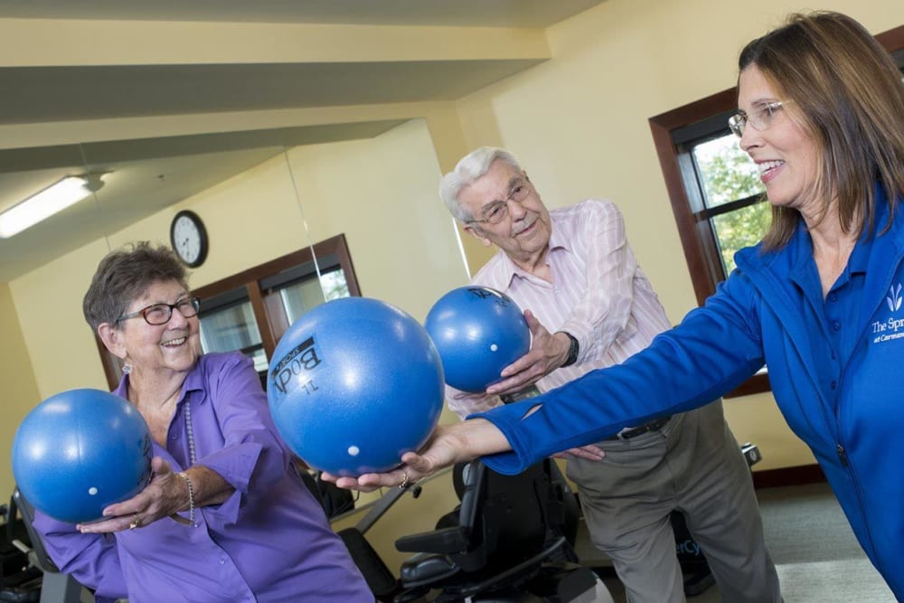 Residents participating in a informative workout class with a staff member at The Springs at Carman Oaks in Lake Oswego, Oregon