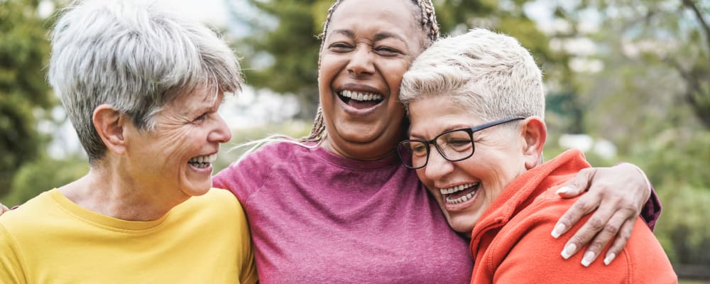 A group of three women embracing at Ridgeline Management Company in Rockwall, Texas