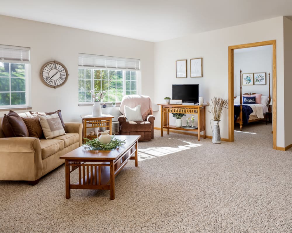 Spacious living room with large windows at Glenwood Place in Marshalltown, Iowa.