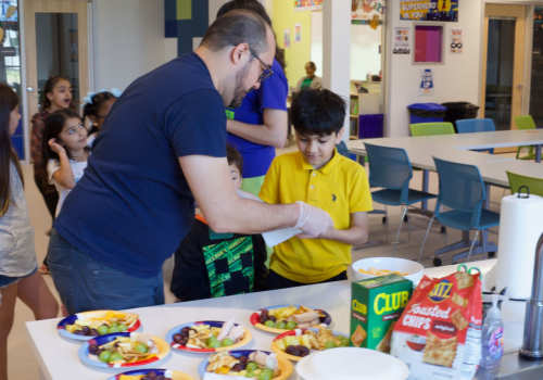 Dad and son cooking together at Parker Lane Apartments in Austin,Texas 