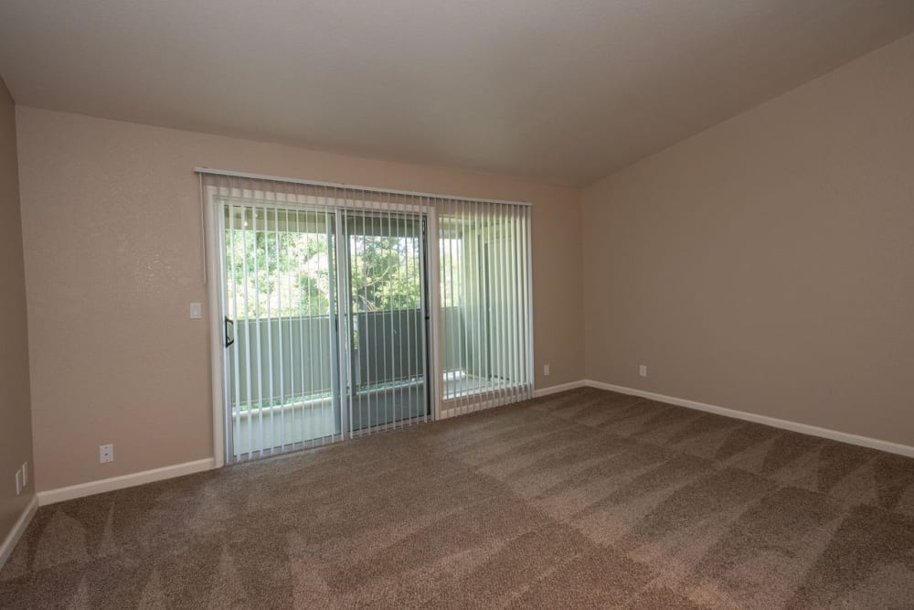 Living room area with balcony at Castle Hill Apartments in Sacramento, California