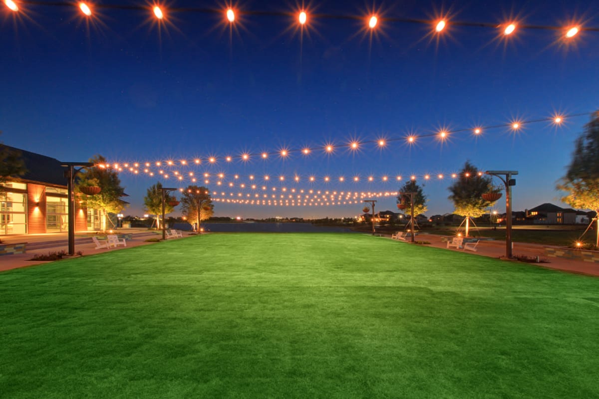 Lush grass area at night at BB Living Harvest in Argyle, Texas