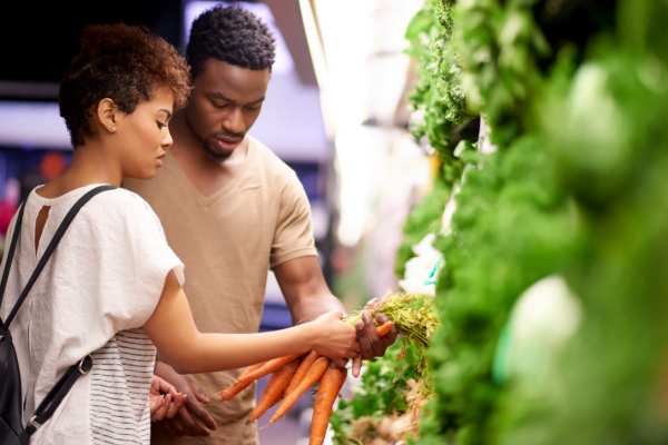 Couple shopping for produce at a market near Evergreen at River Oaks in Lake Charles, Louisiana