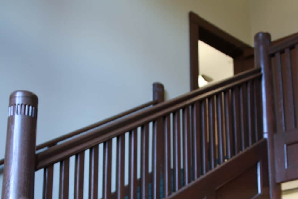 Staircase with wooden railing at Bh Tapley Court in Springfield, Massachusetts