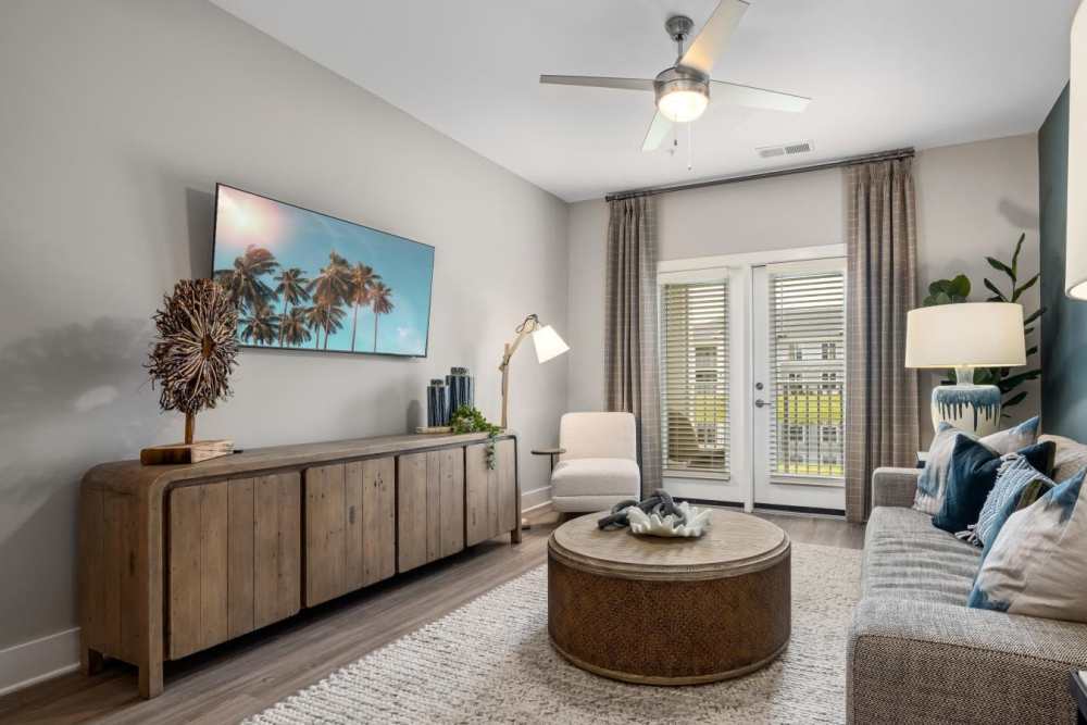 Open layout carpeted living room with plenty of room for a couch, coffee table, and more at Hudson Carolina Forest in Myrtle Beach, South Carolina