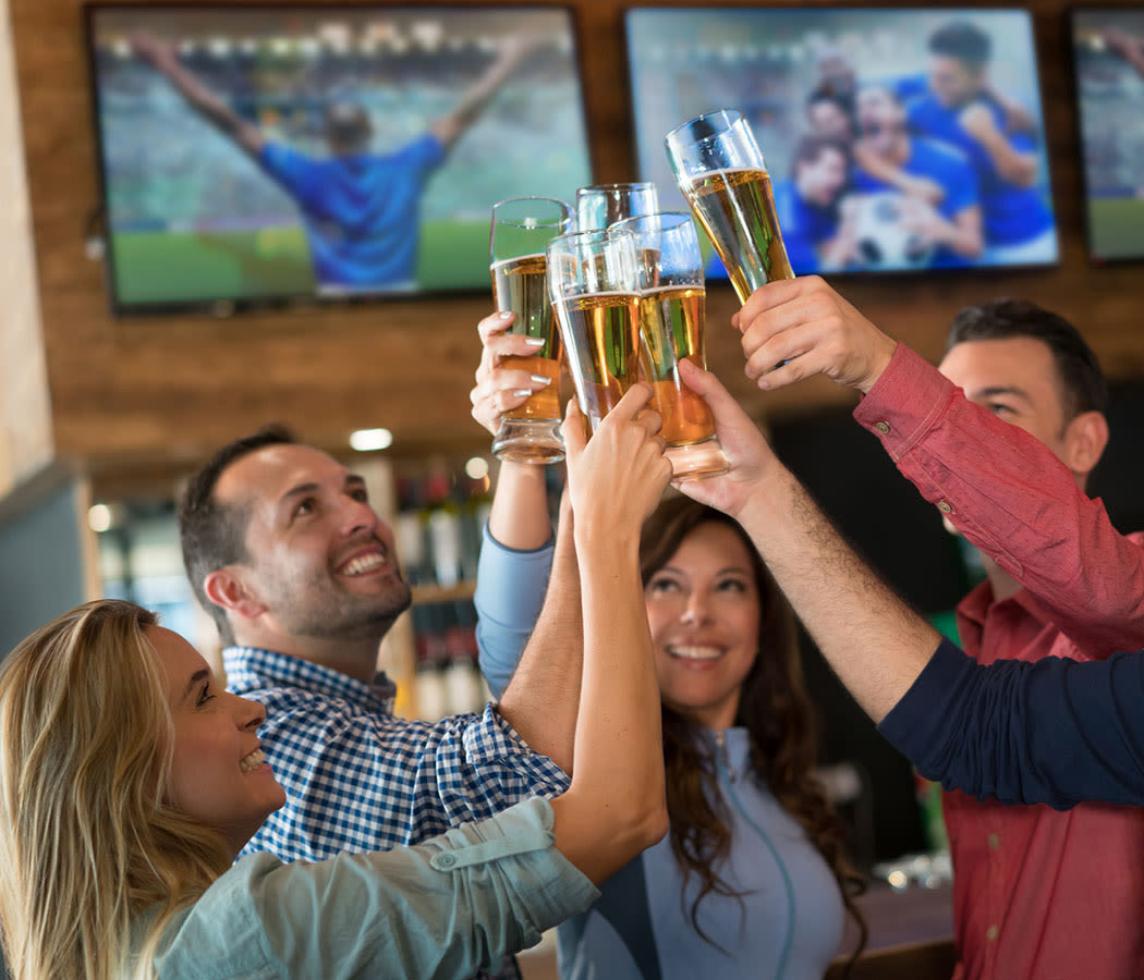 People doing cheers at a restaurant near 2803 Riverside in Grand Prairie, Texas