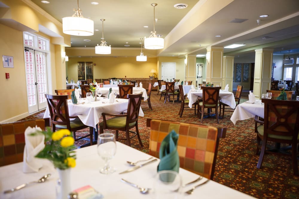 Well decorated dining room tables at Harmony at Falls Run in Fredericksburg, Virginia