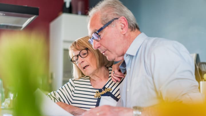 Older couple looking over paperwork in a home