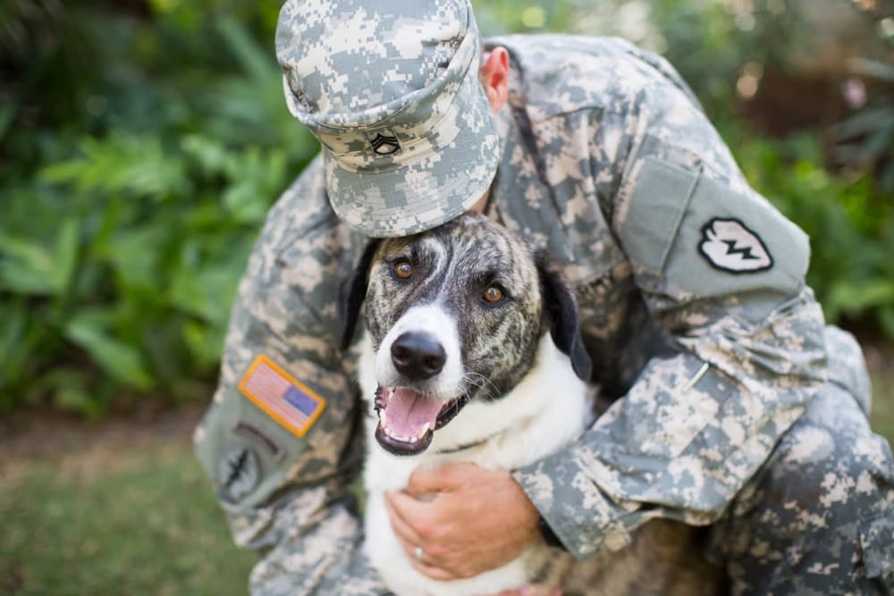 Resident with his puppy at United Communities in Joint Base MDL, New Jersey