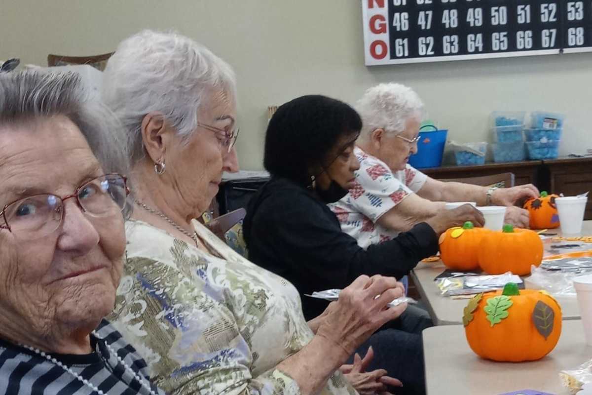 Resident being assisted by staff member at Isle at Raider Ranch in Lubbock, Texas
