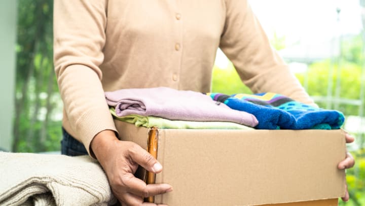 A person holding a box for donations