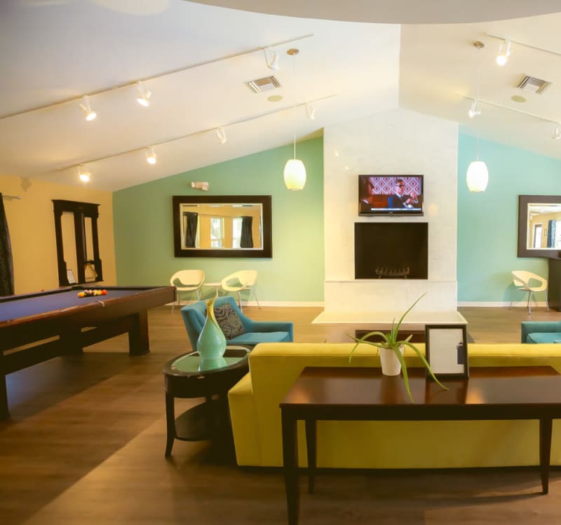 Game room with a billiards table and more in the resident clubhouse at Signal Pointe Apartment Homes in Winter Park, Florida