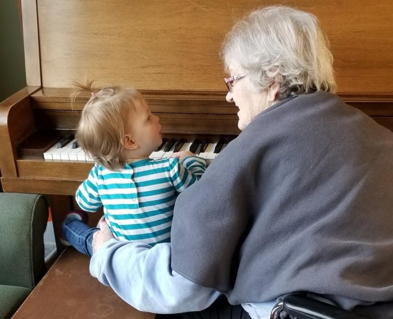 A resident teaching a child the piano at Ebenezer Ridges Campus in Burnsville, Minnesota