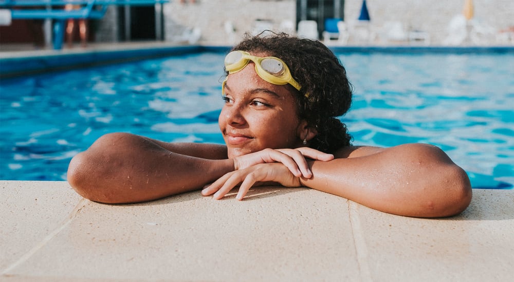 Resident smiling at the pool's edge after swimming some laps at a Mission Rock at Novato community in Novato, California